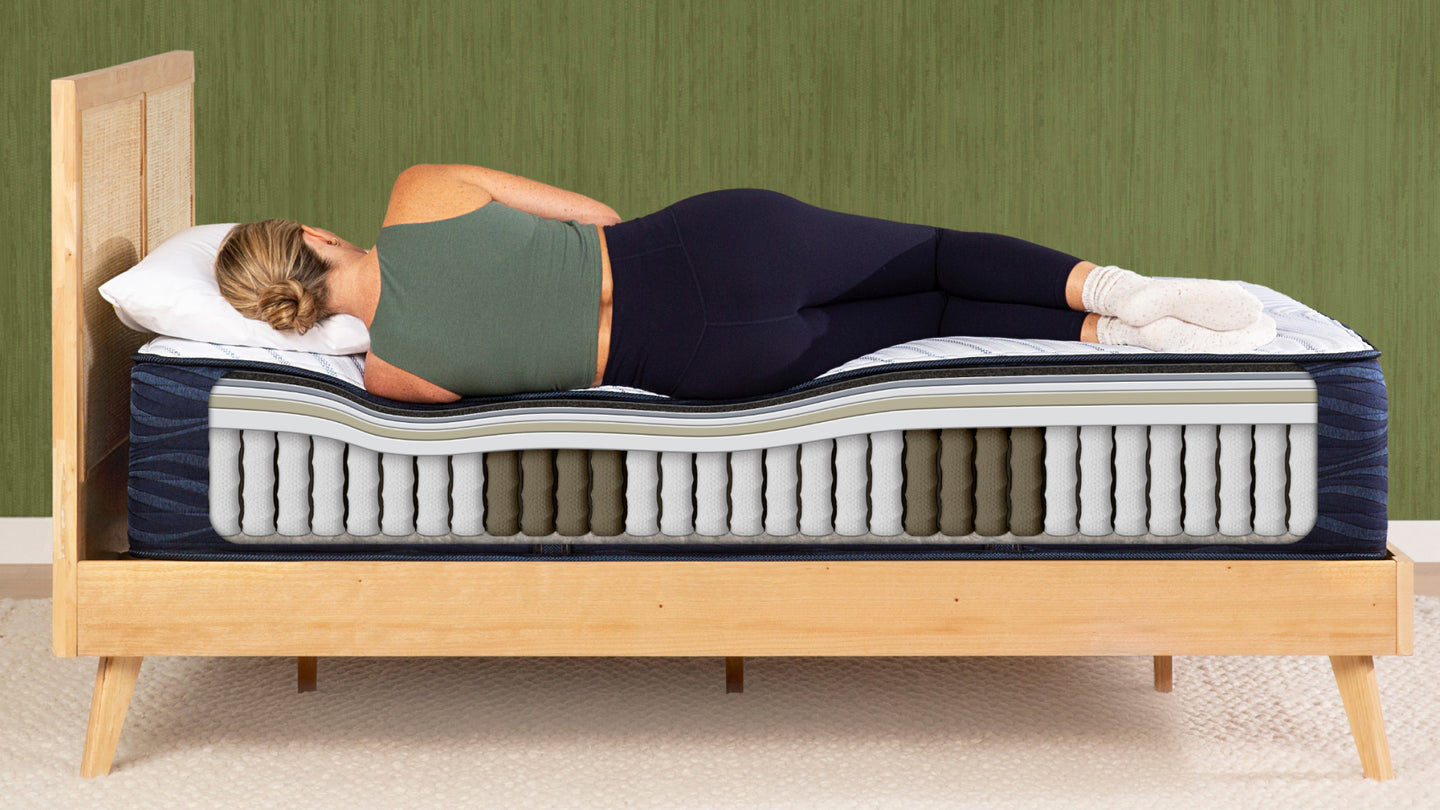 woman lying on her side on a mattress