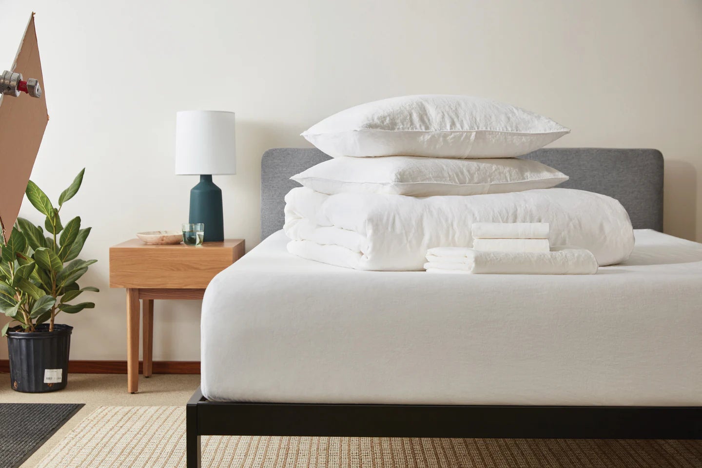 Modern bedroom with neatly stacked bedding