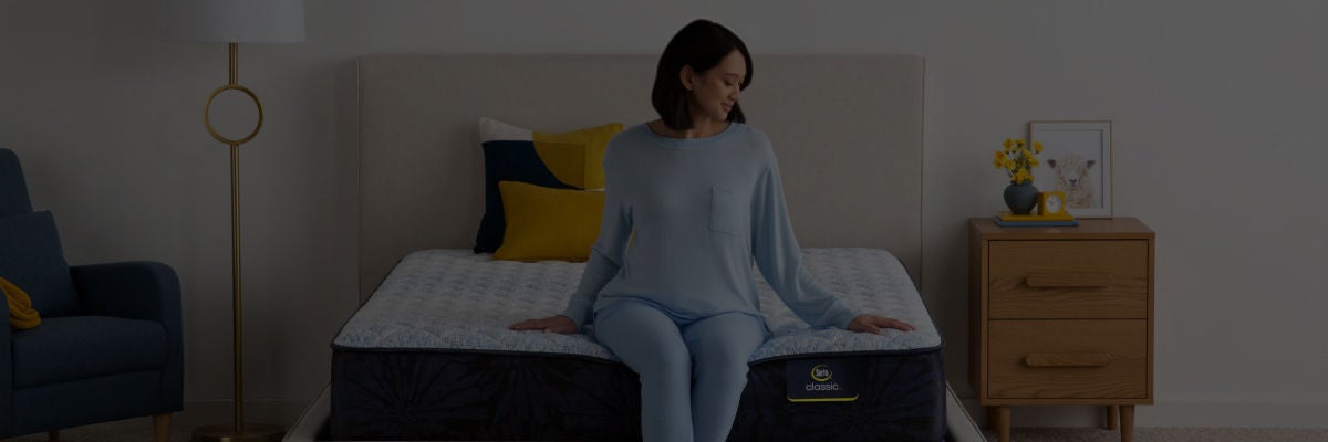 Woman sitting on top of a Serta mattress