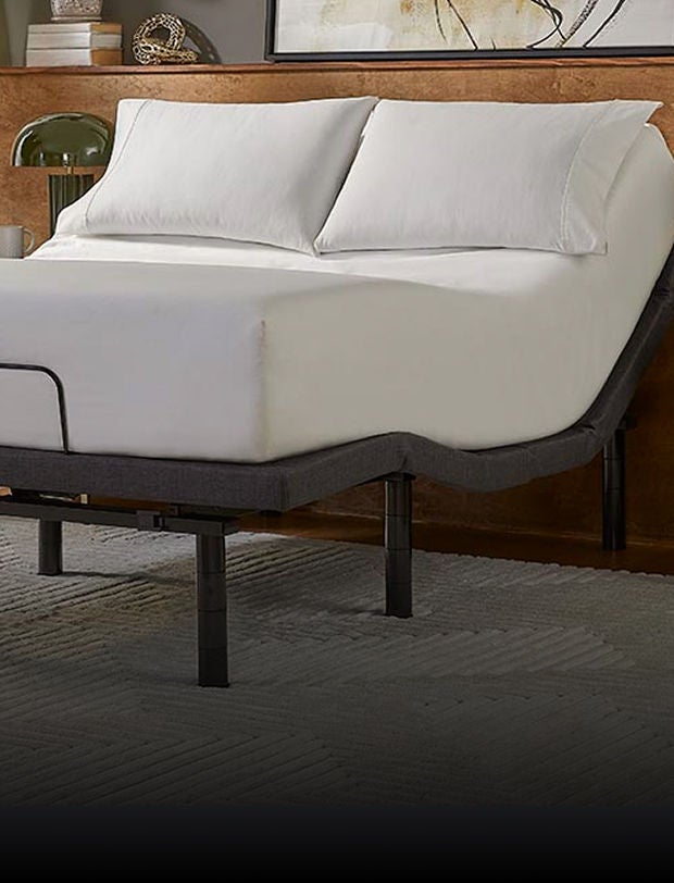 Serta mattress with 2 pillows on top of in an adjustable base slightly raised at the head of the bed.
