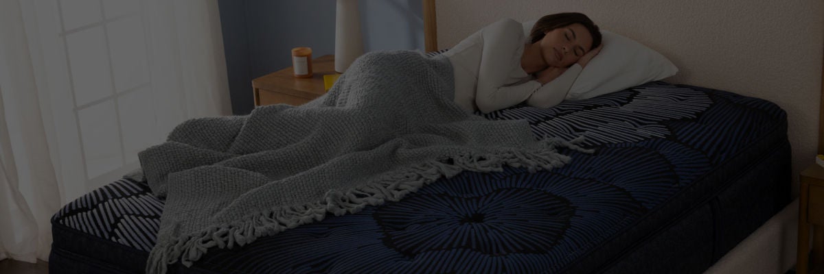 Woman laying asleep on top of a Serta mattress