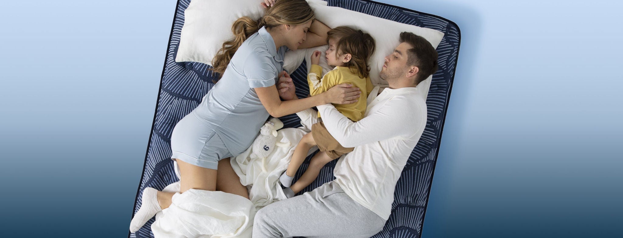 Family relaxing on a striped mattress