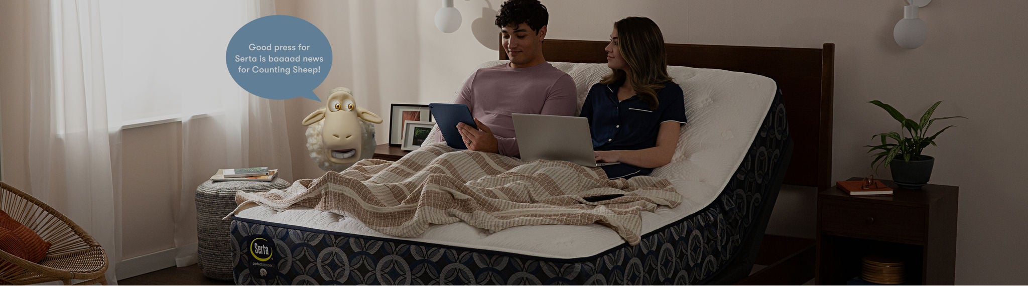 Man and woman sitting up on a Serta Queen mattress elevated on an adjustable base. The man using his tablet and a woman using her laptop. with a Serta sheep to the right of the mattress with a caption over its head stating Good press for Serta is baaaaad news for Counting Sheep!