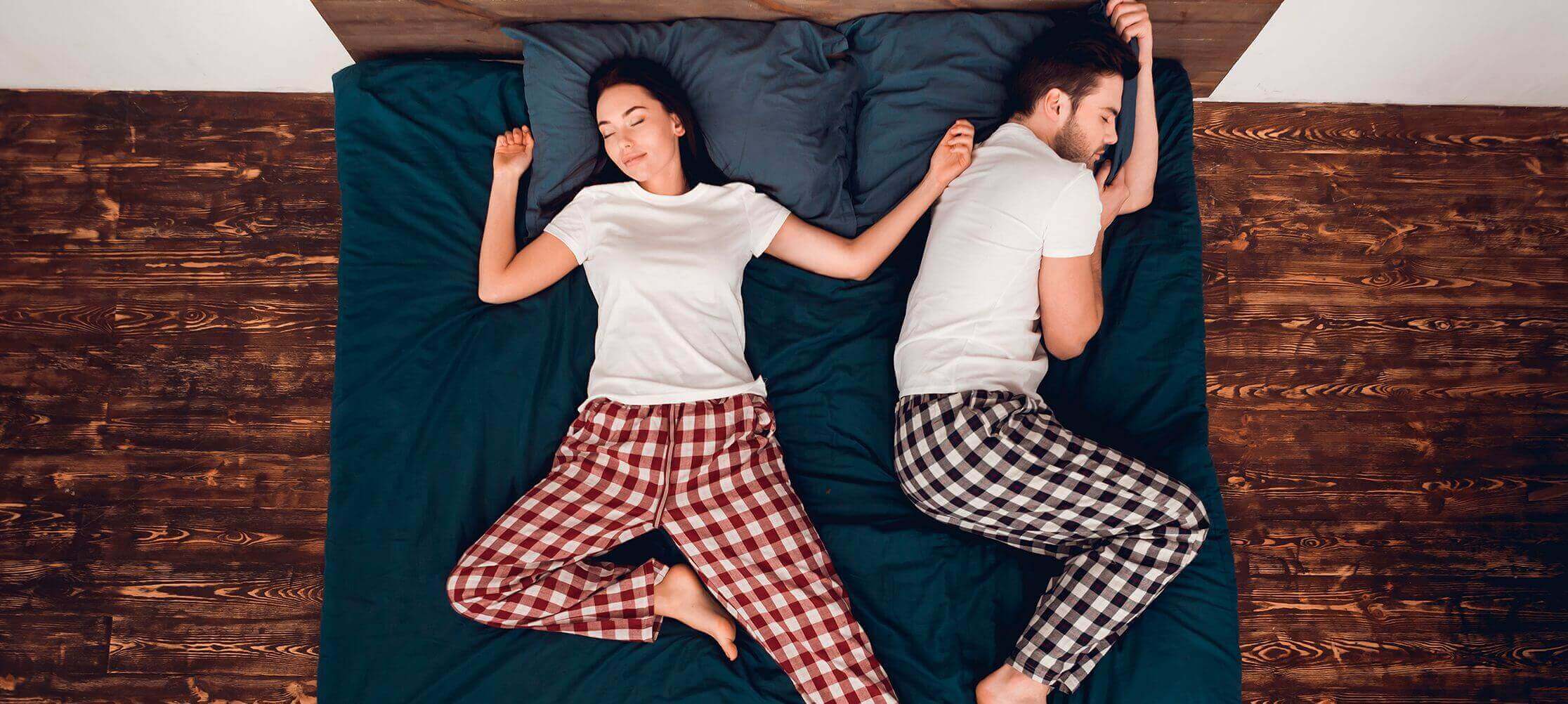 Couple in plaid pajamas lying in bed