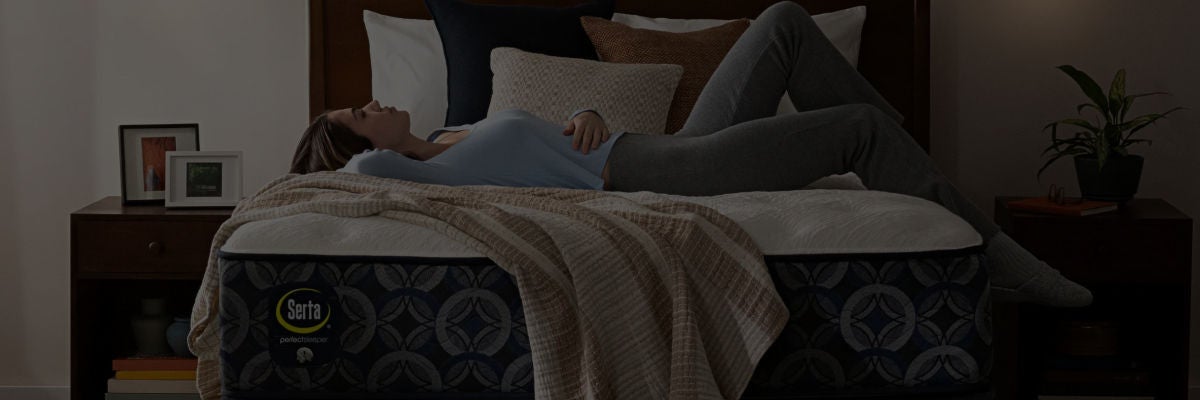 Woman laying on her back on top of a Serta mattress