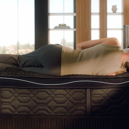 Woman resting on ergonomic mattress