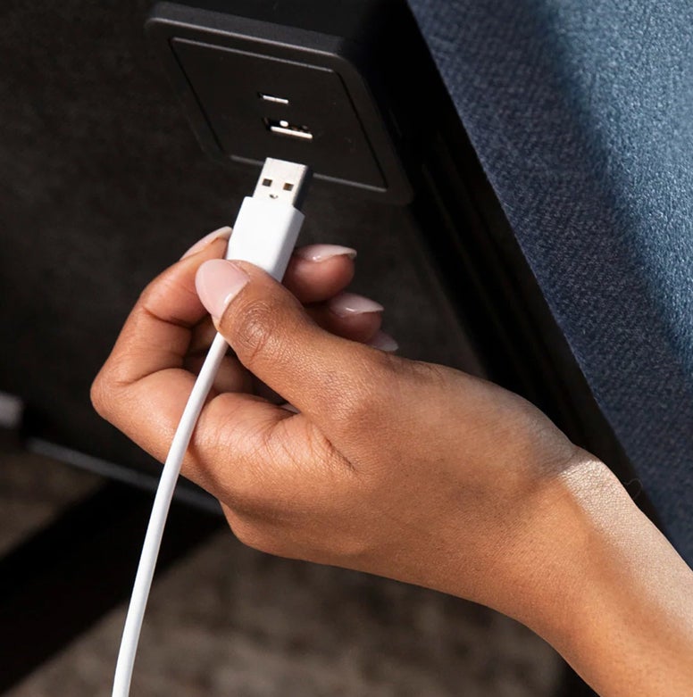 Hand plugging USB cable into socket