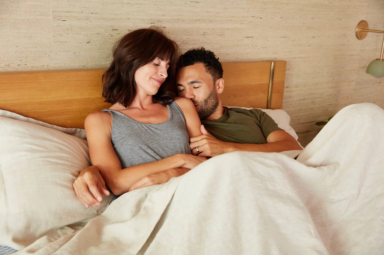 Couple relaxing in cozy bedroom setting