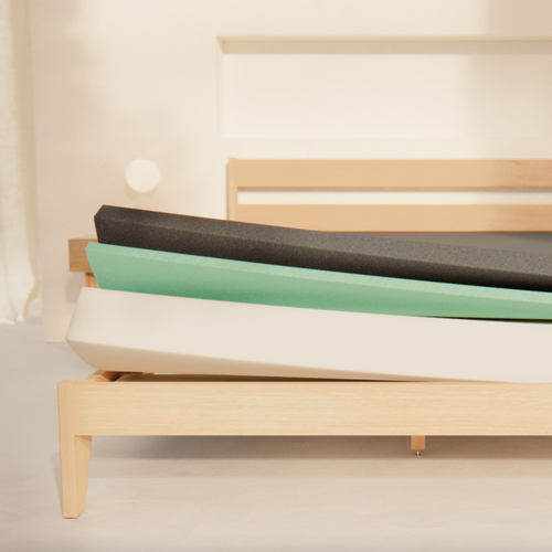 Layered foam mattresses on wooden frame