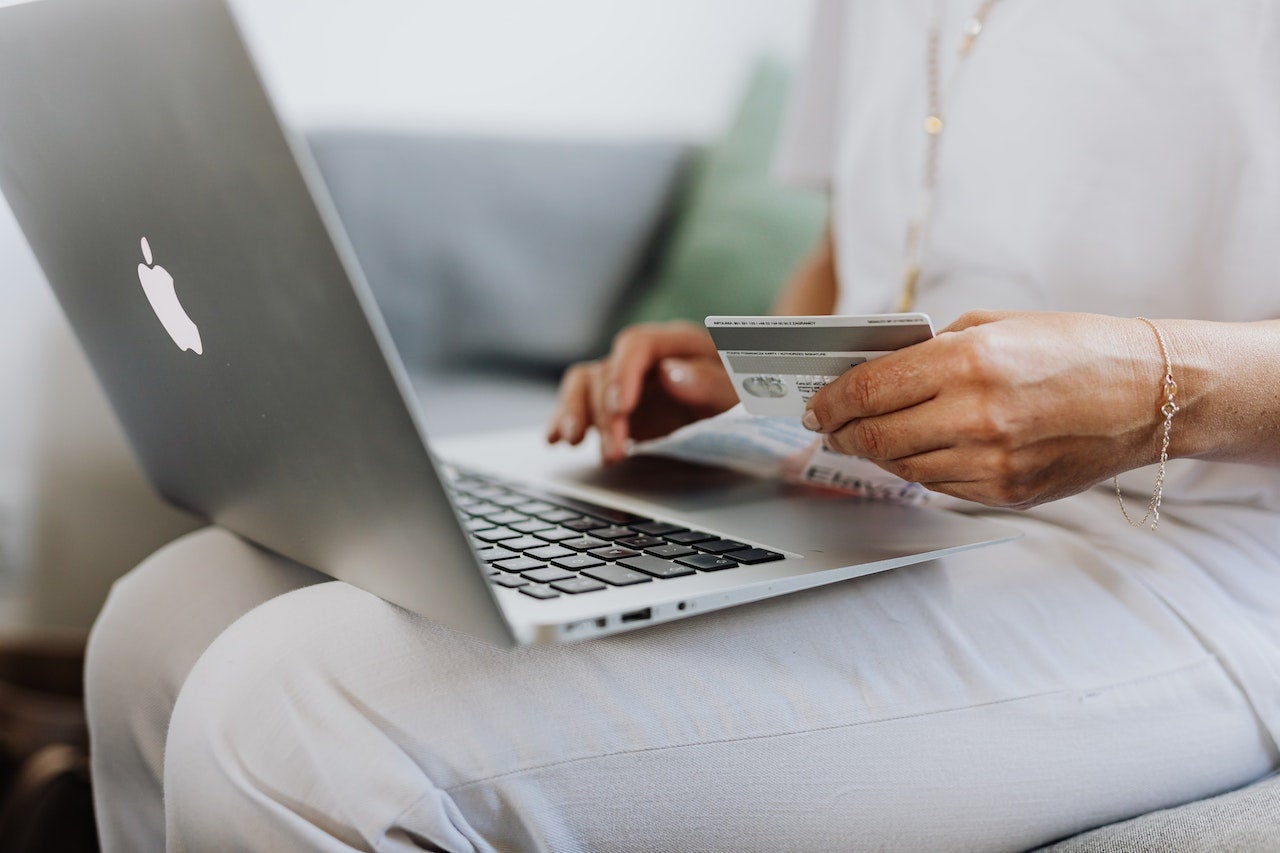 Woman shopping online with laptop and card
