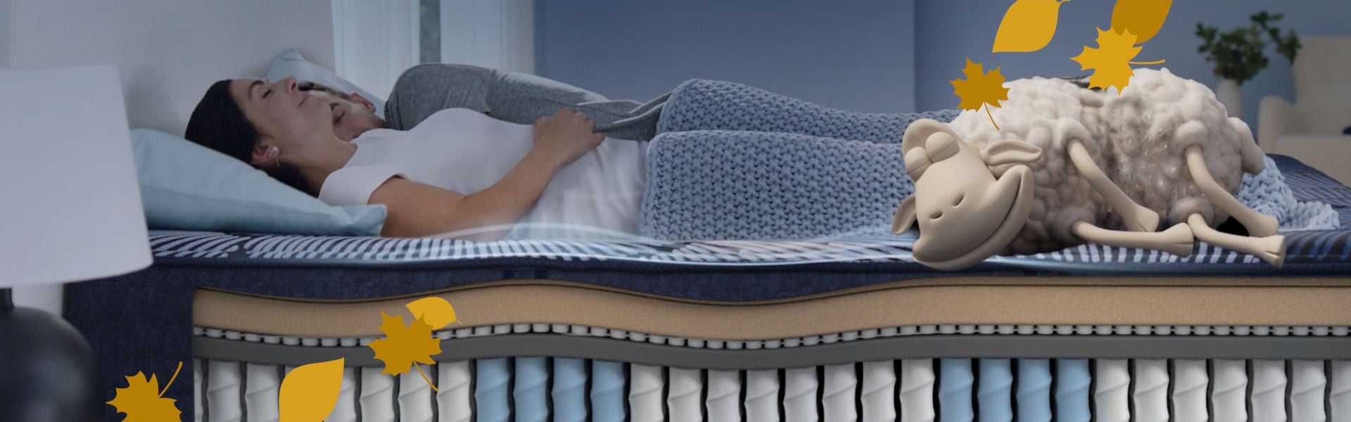 woman on comfy bed with fall leaves graphic