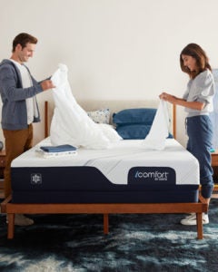 Couple setting up Serta iComfort mattress