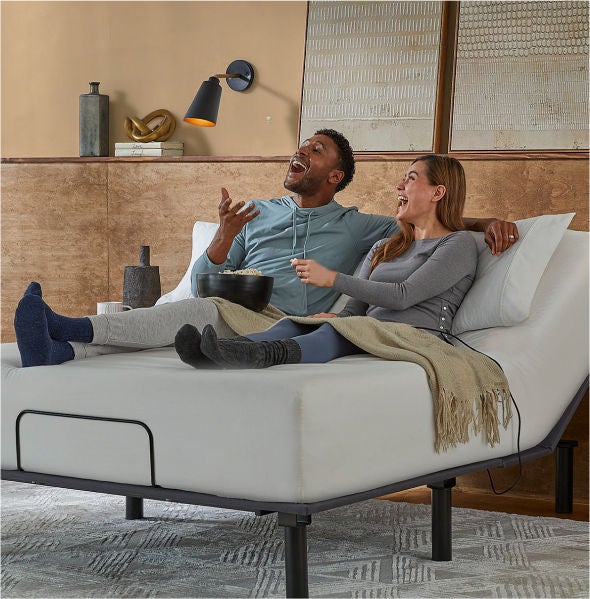 Couple relaxing on adjustable bed