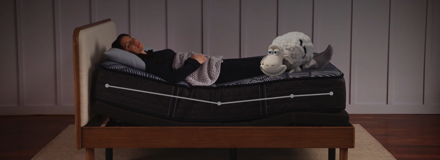serta sheep laying on an adjustable bed frame