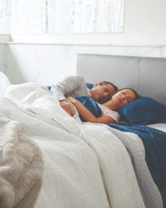 Couple sleeping peacefully in modern bedroom