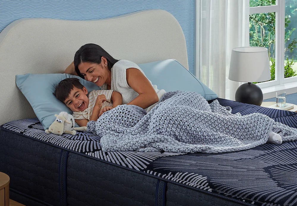 Mother and child resting on bed