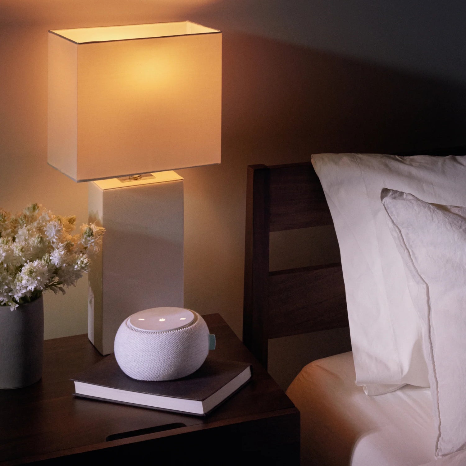 Smart speaker on bedside table at night