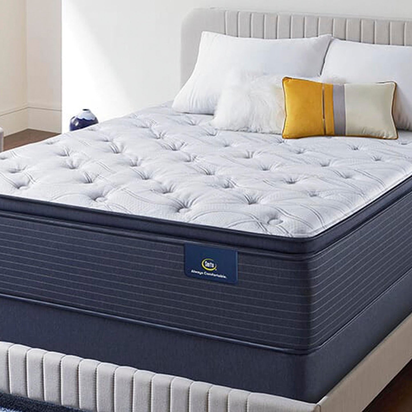 The Serta Classic Elite Plush Pillow Top 15" in a bedroom on a bed with pillows