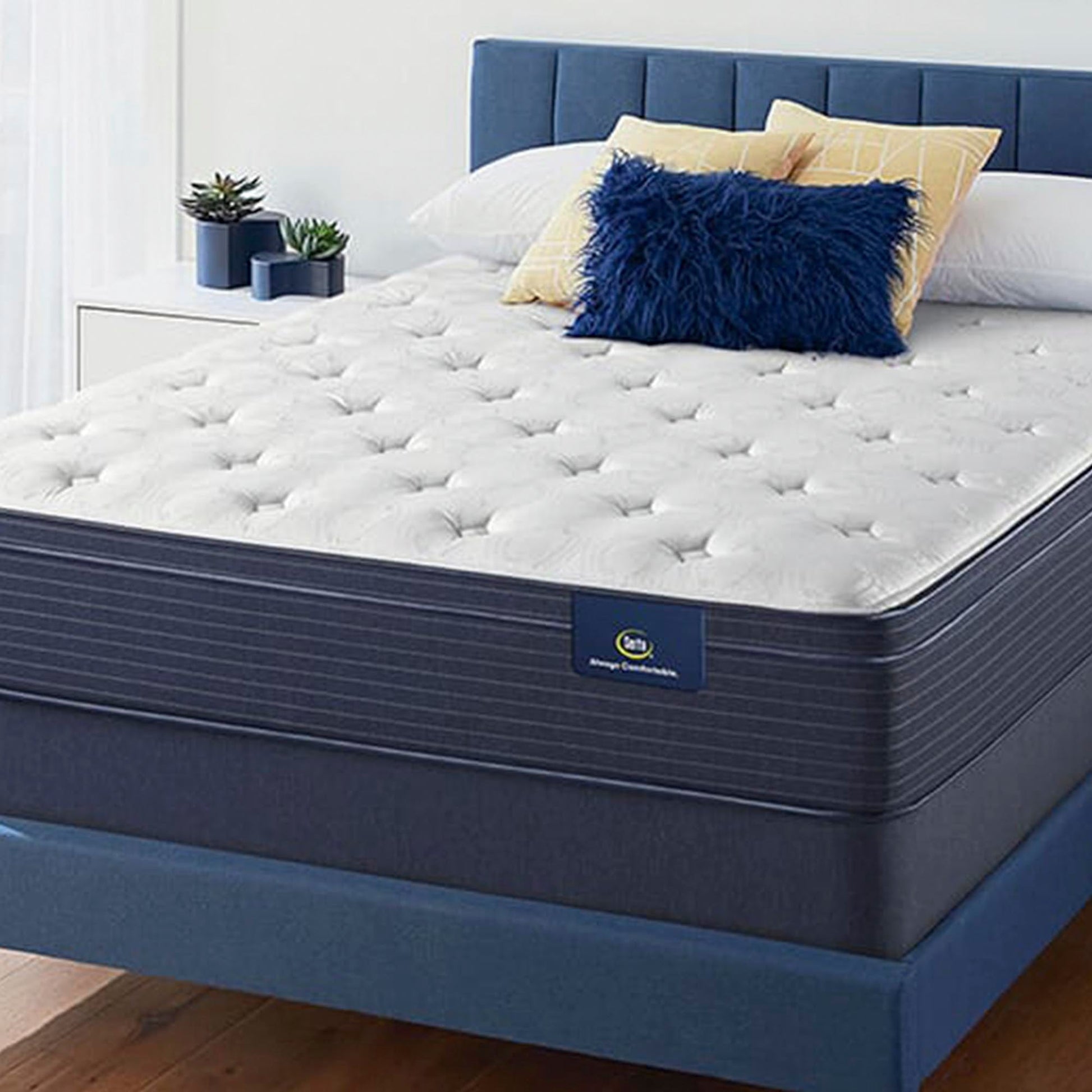 The Serta Classic Plush EuroTop 11.5" on a blue bed with blue and yellow pillows