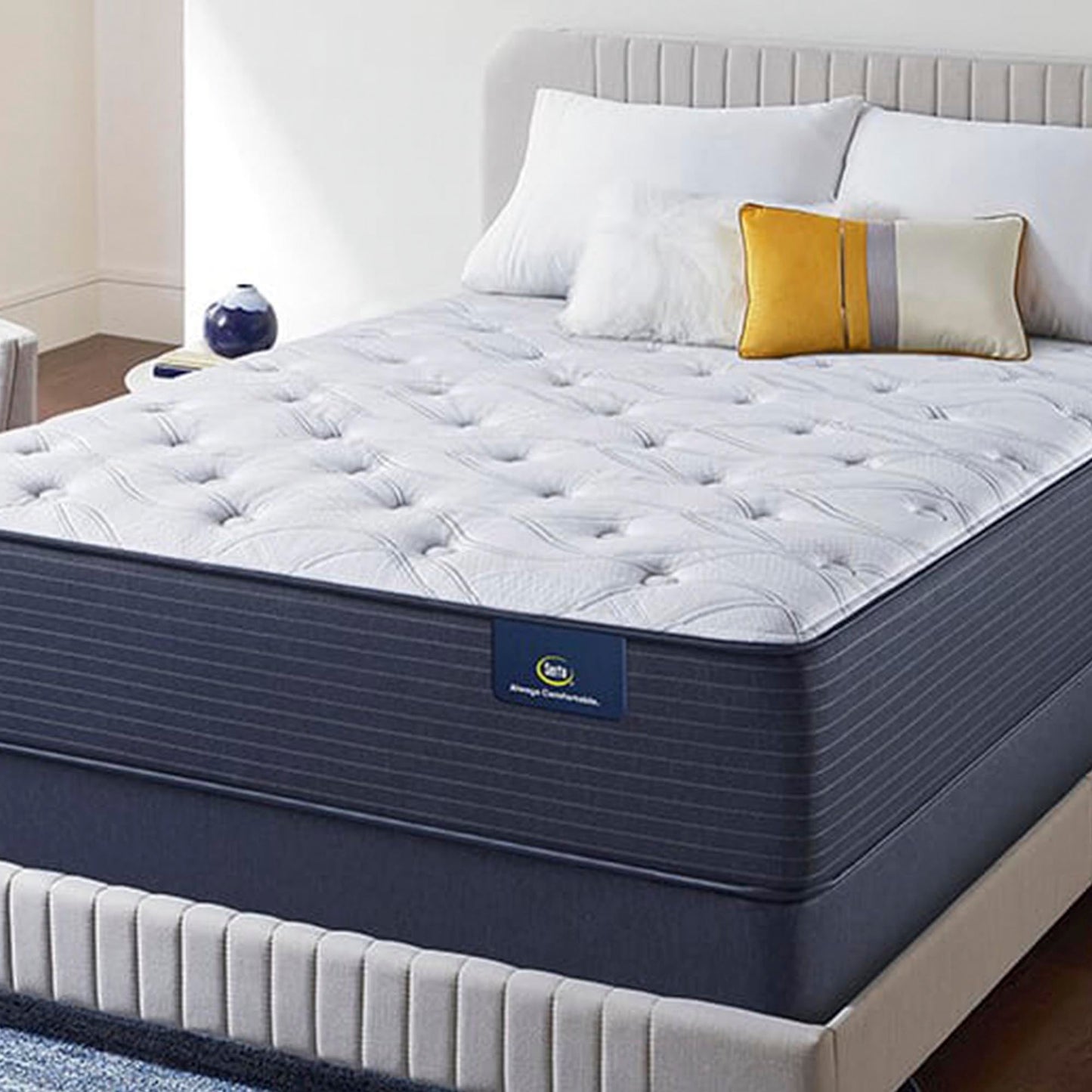 The Serta Classic Elite Plush 14" in a bedroom on a beige bed with pillows
