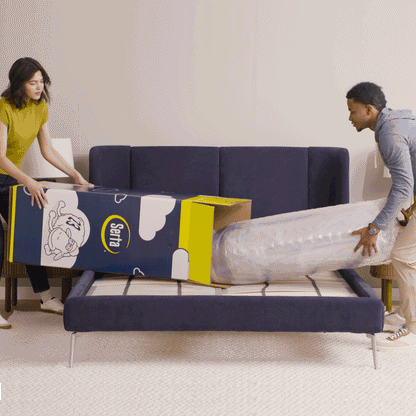 Gif video of a couple opening a mattress in a box, unrolling it and then laying on it.