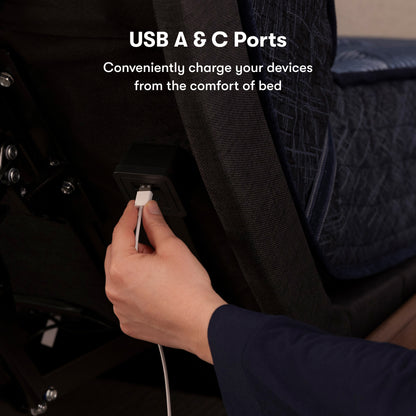 A hand of a female plugging a power cord into the back of the USB port on the back of the adjustable base. 
