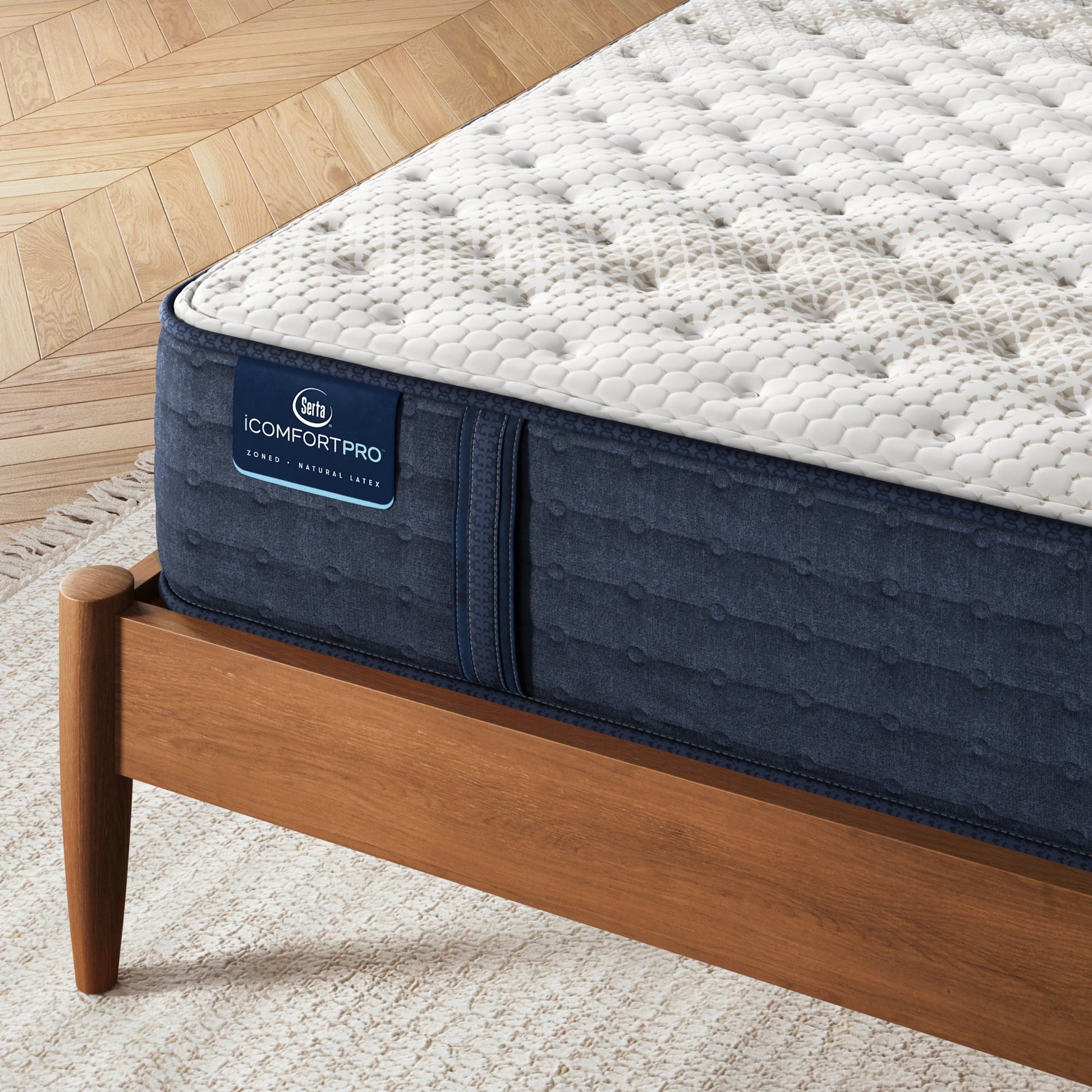 Corner iComfortPro Chelsea Medium Mattress sitting in a brown bedframe || feel: medium || level: Level 1