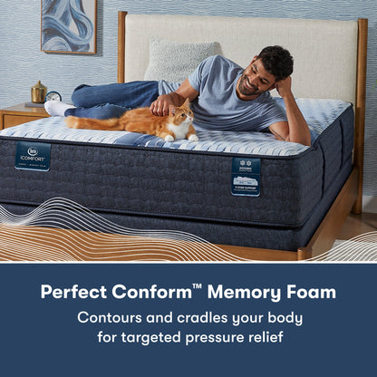 Man laying across a Serta iComfort mattress petting a cat || feel: firm || level: Standard - 11.5"