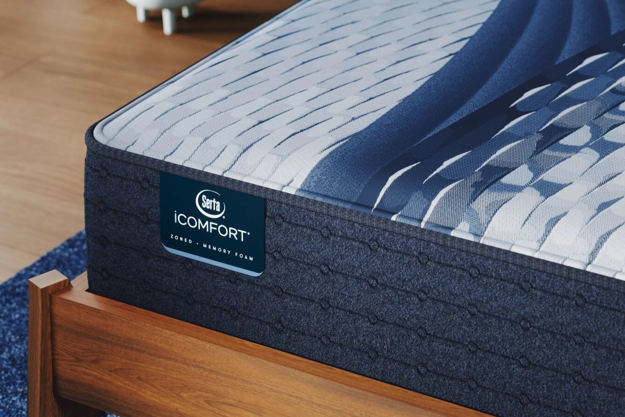 Close-up of a Serta iComfort Firm mattress, featuring 5-zone support, pressure-relieving memory foam, and cool-to-the-touch fabric