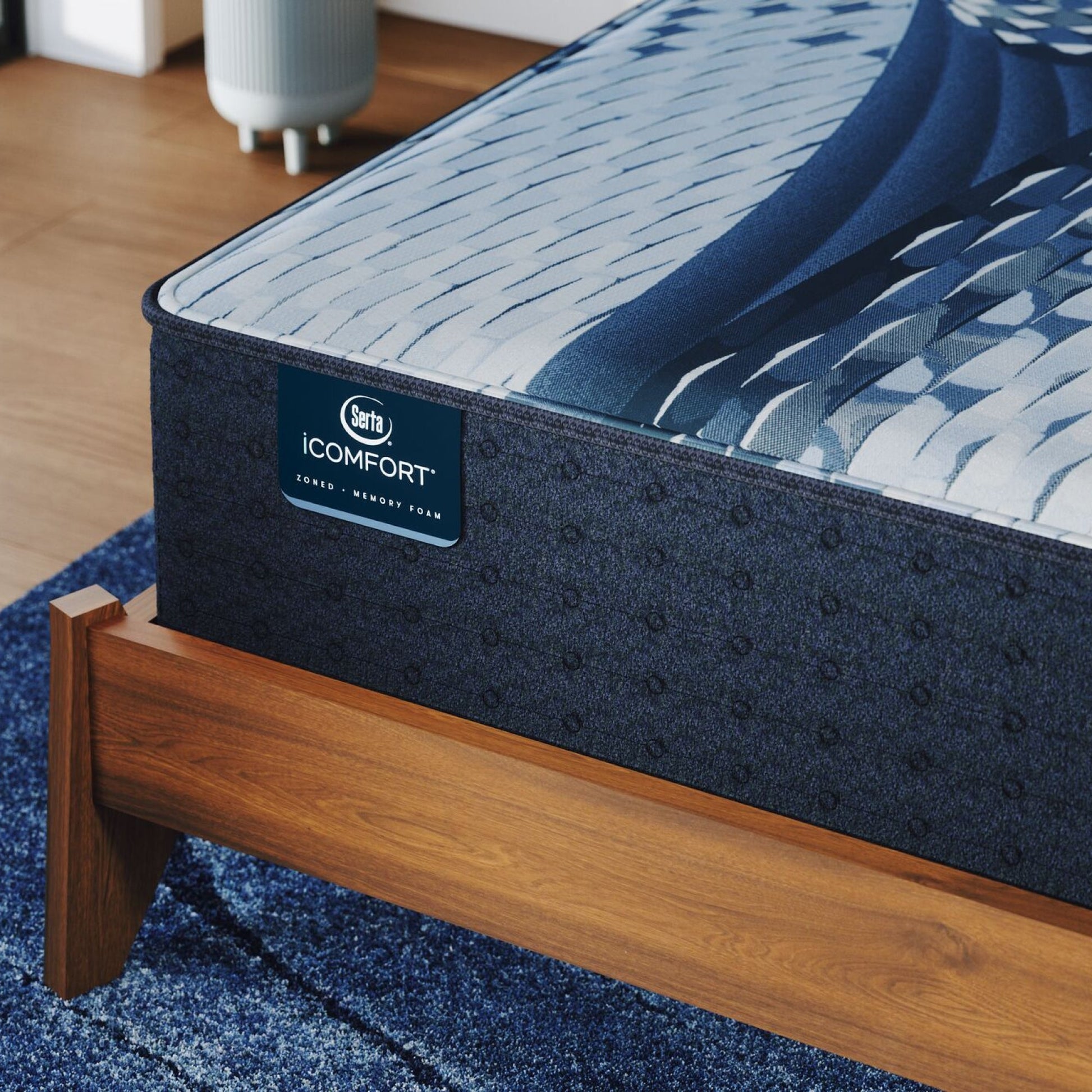 Corner of a iComfort Iona Plush Mattress sitting in a brown bedframe || feel: plush || level: Standard - 13"