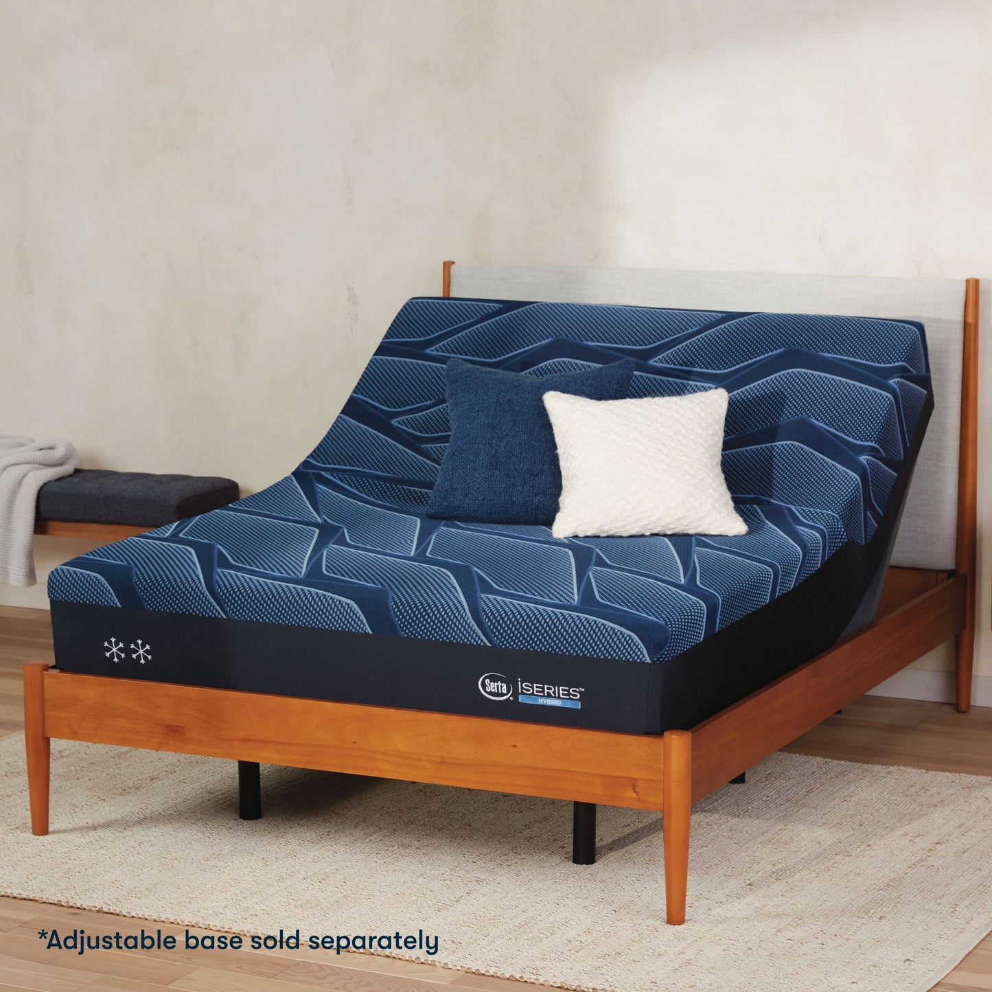 Serta iSeries firm blue mattress sitting in a adjustable frame, in a brown bed with a blue and white pillow on top||feel: firm||level: enhanced