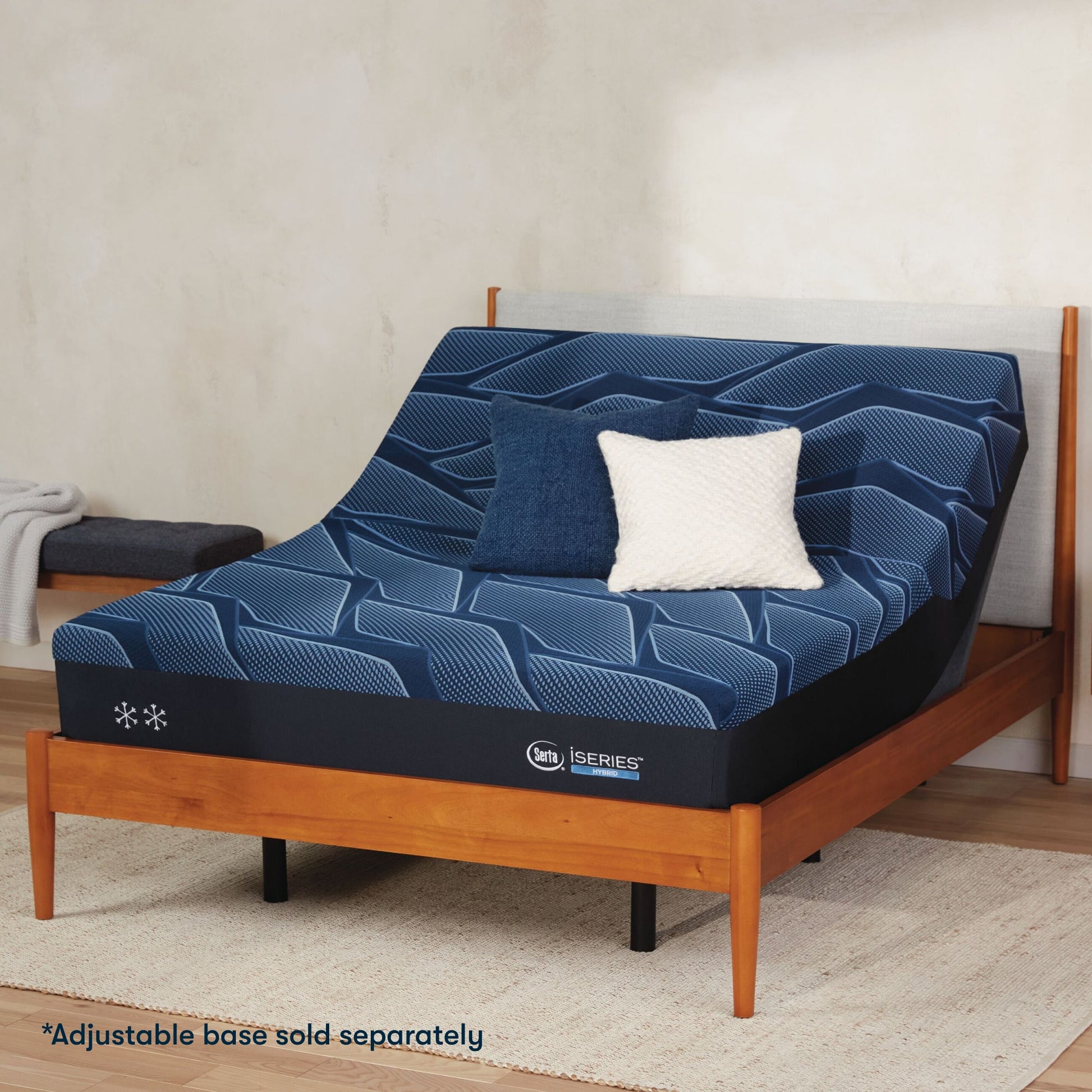 Serta iSeries firm blue mattress sitting in a adjustable frame, in a brown bed with a blue and white pillow on top||feel: firm||level: enhanced