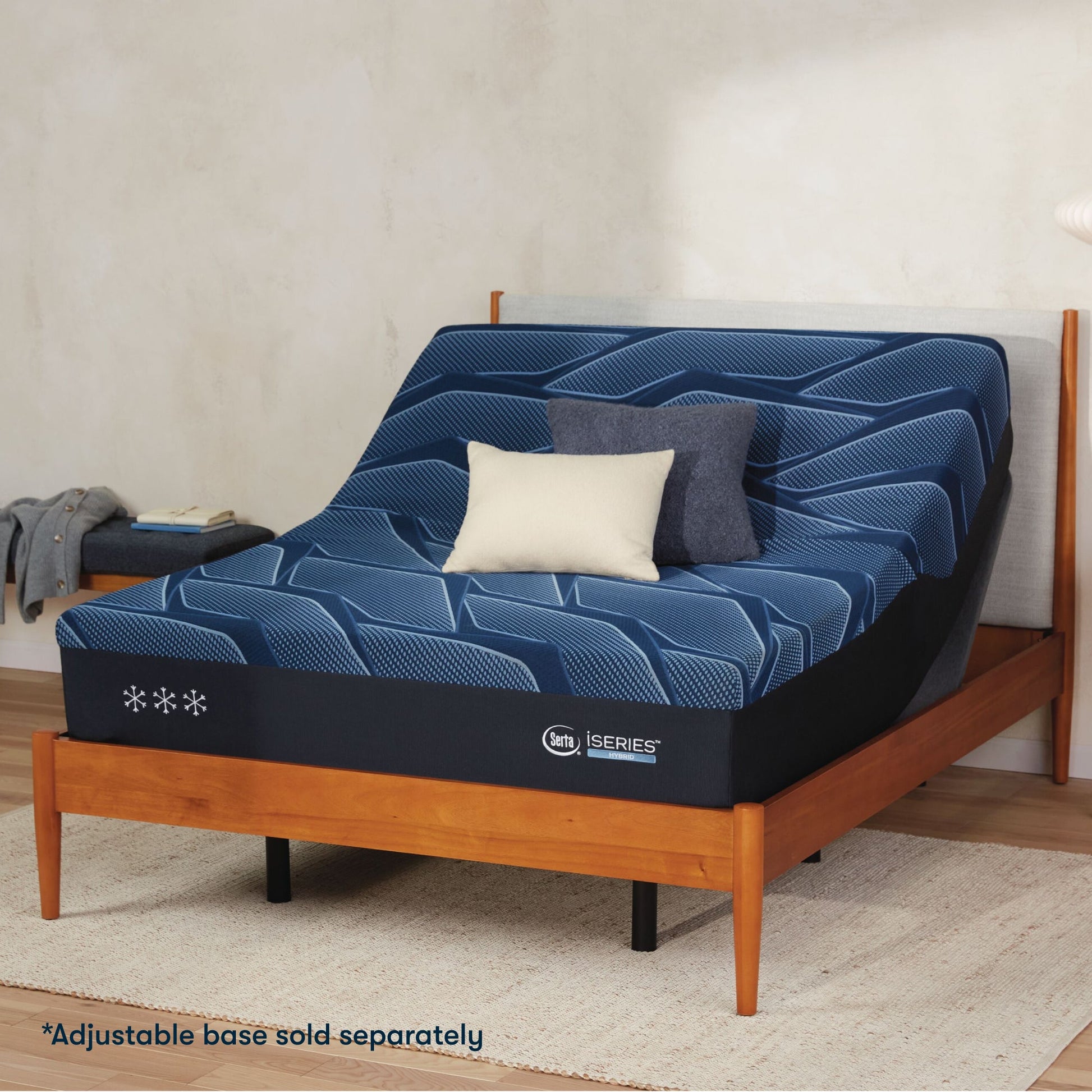 Serta iSeries plush blue mattress sitting in a adjustable frame, in a brown bed with a blue and white pillow on top||feel: plush||level: Ultimate