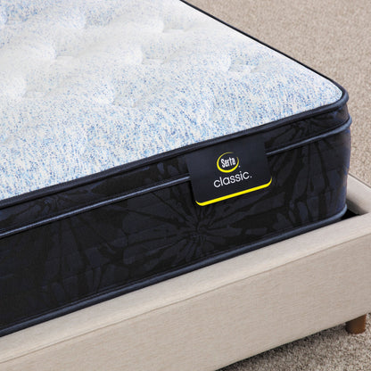 Corner of Serta classic dorian plush euro top mattress sitting in a beige bed frame ||feel: plush euro top ||level: standard