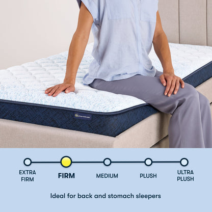 Woman sitting on the right of a 6 inch foam mattress sitting in a beige bedframe || feel: Foam (6" Profile)