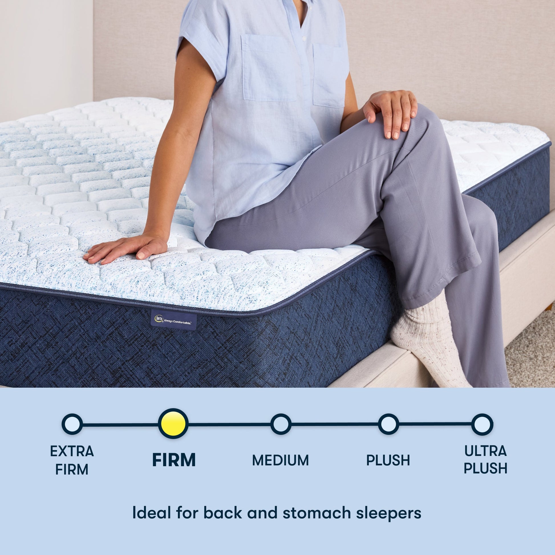 Woman sitting on the right of a 11 inch hybrid mattress sitting in a beige bedframe || feel: Firm