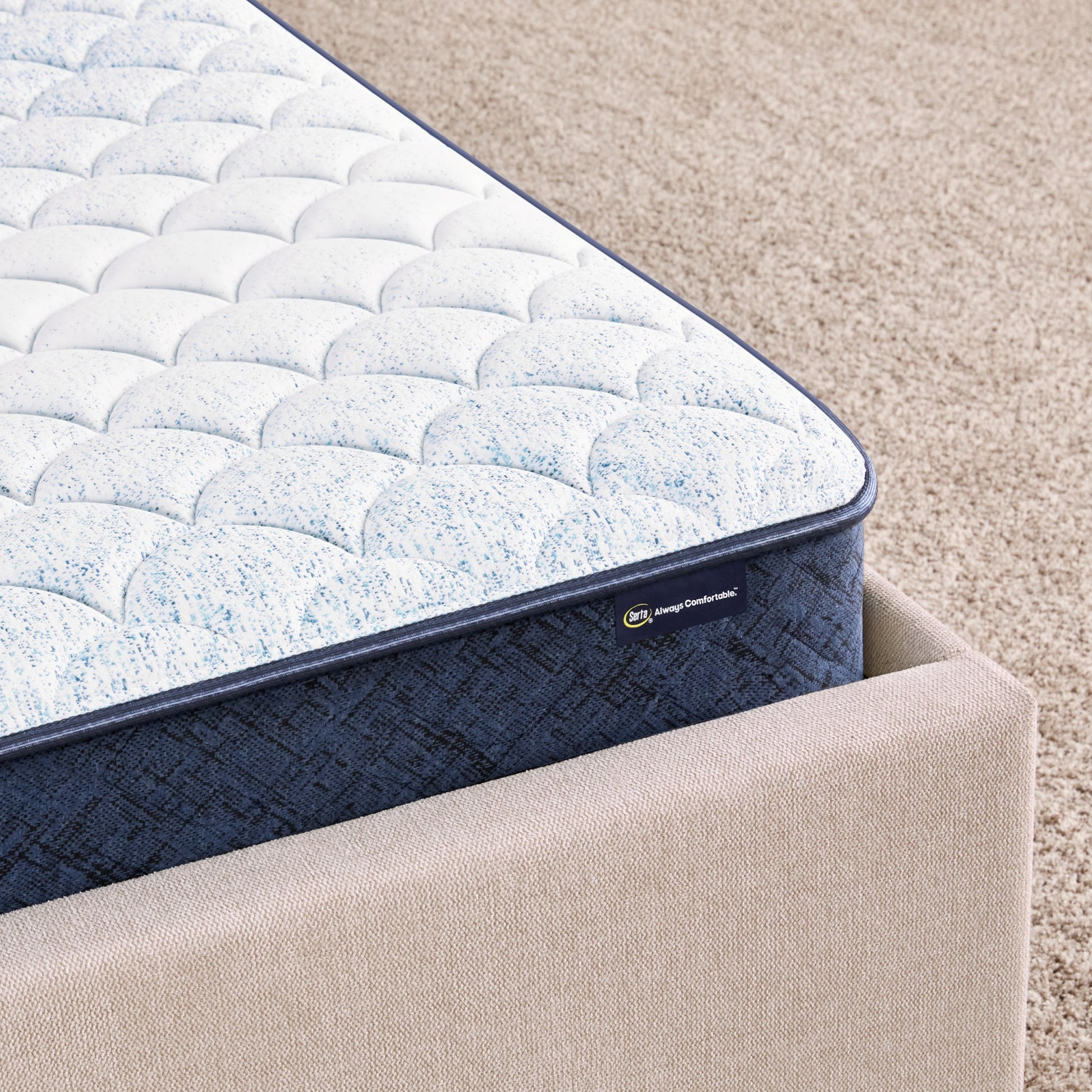 Corner of 6 inch foam mattress sitting in a beige bedframe || feel: Foam (6" Profile)