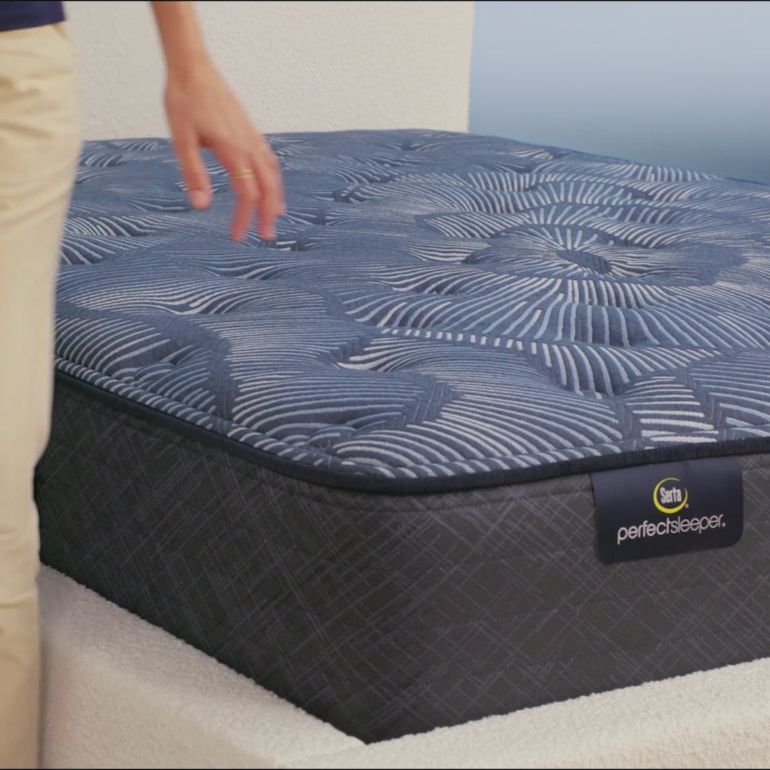 Person sitting on bed to show firmness level of Serta Perfect Sleeper plush mattress||feel: plush||level: ultimate