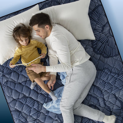 Little boy and father reading in bed on a Serta Perfect Sleeper mattress||feel: plush||level: ultimate