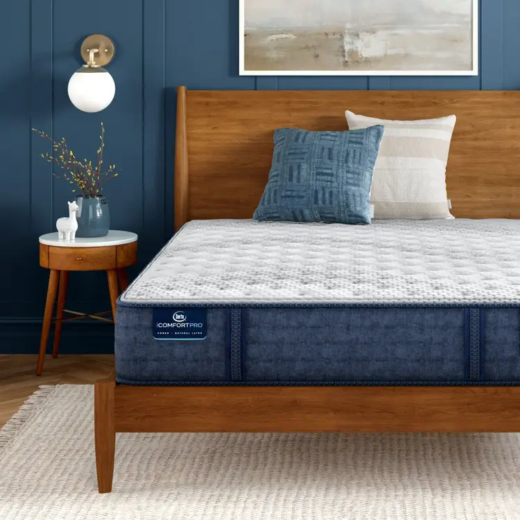 iComfortPro Granby Extra Firm Mattress sitting in a brown bedframe || feel: extra firm || level: Level 1