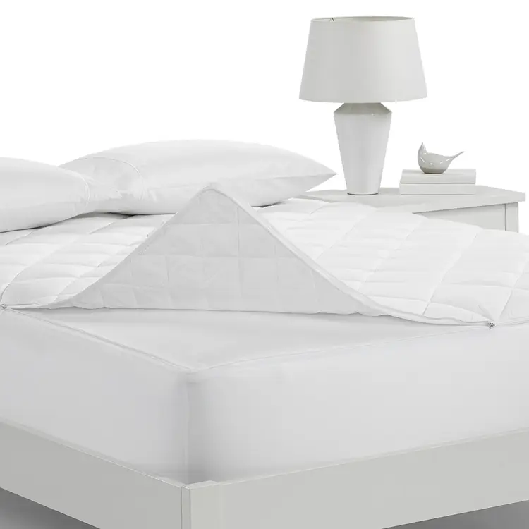 Serta Air Dry Extra Comfort Plus Mattress Pad on top of of a mattress turned up at the corner of the mattress.