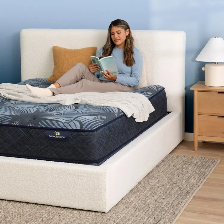 A woman reading in bed on the Serta Perfect Sleeper Sleep Excellence mattress | feel: medium pillow top