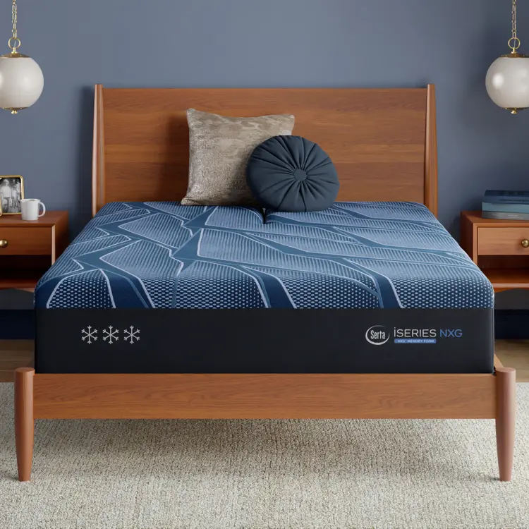 Blue Serta iSeries NXG mattress with a brand logo on a wooden bed frame in a bedroom setting.