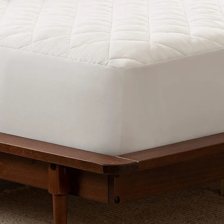 A closeup of the corner of Serta Power Clean Waterproof Mattress Pad on a bed