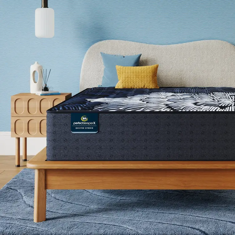 Perfect Sleeper X Quilted Hybrid Max Medium Mattress sitting in a brown bedframe || feel: Medium || level: Level 2