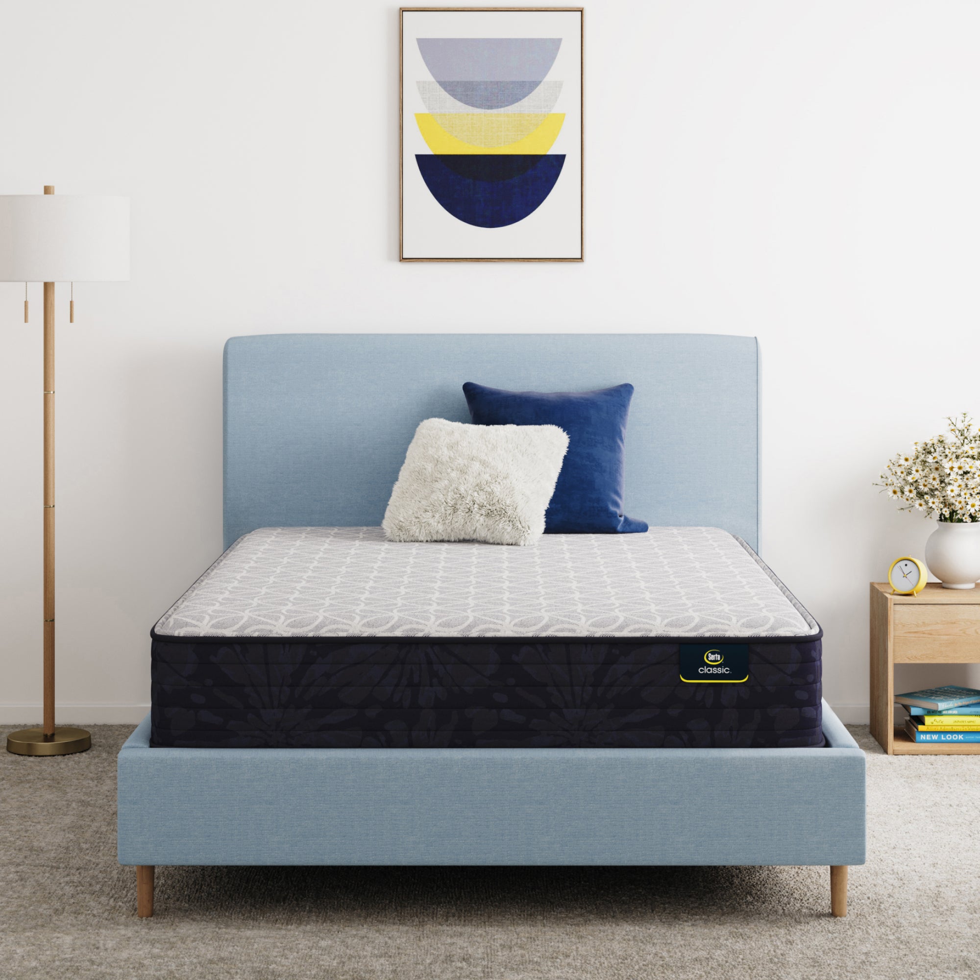 Serta Classic Clarks Hill Mattress on a bed with a blue headboard in a room setting