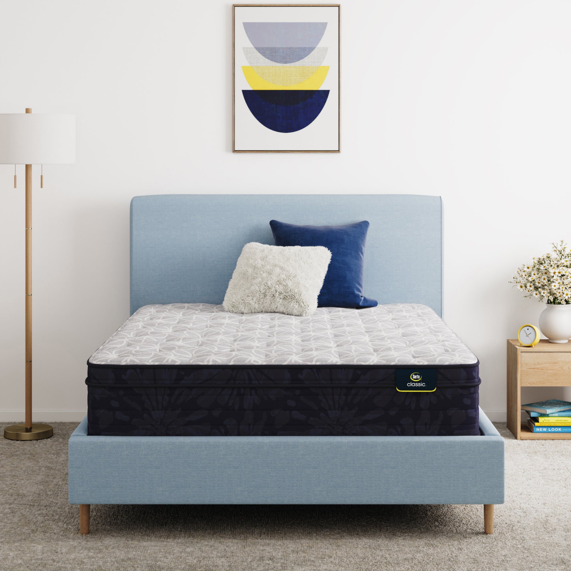 Serta Classic Clarks Hill 12.5" mattress sitting in a blue bed frame with 2 pillows on top of it.