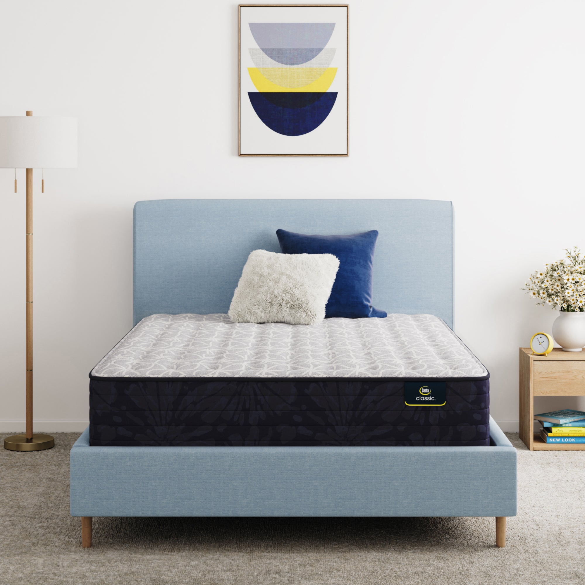 Serta Classic Clarks Hill 13" mattress sitting in a blue bed frame with 2 pillows on top of it.