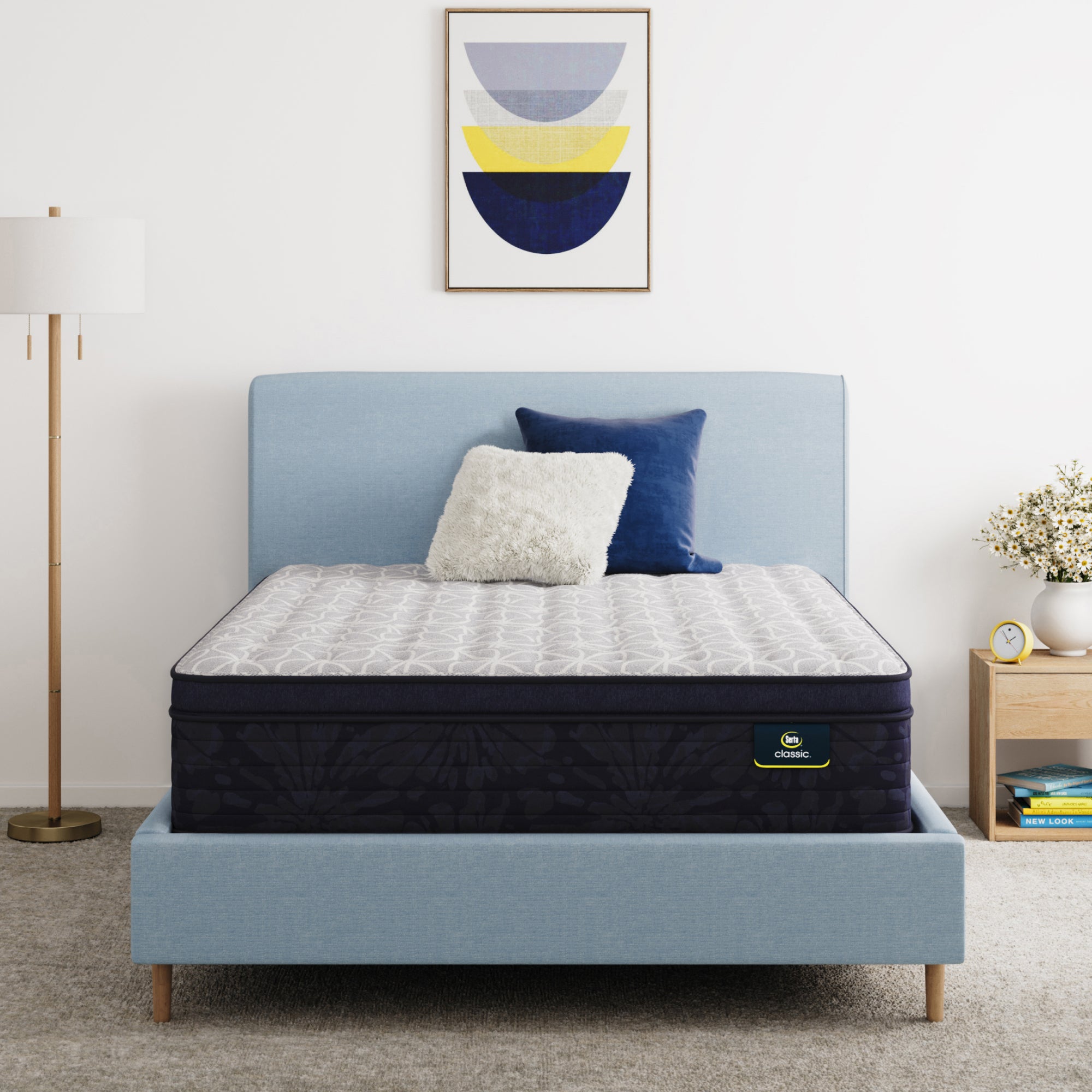 Serta Classic Clarks Hill 14.5" mattress sitting in a blue bed frame with 2 pillows on top of it.