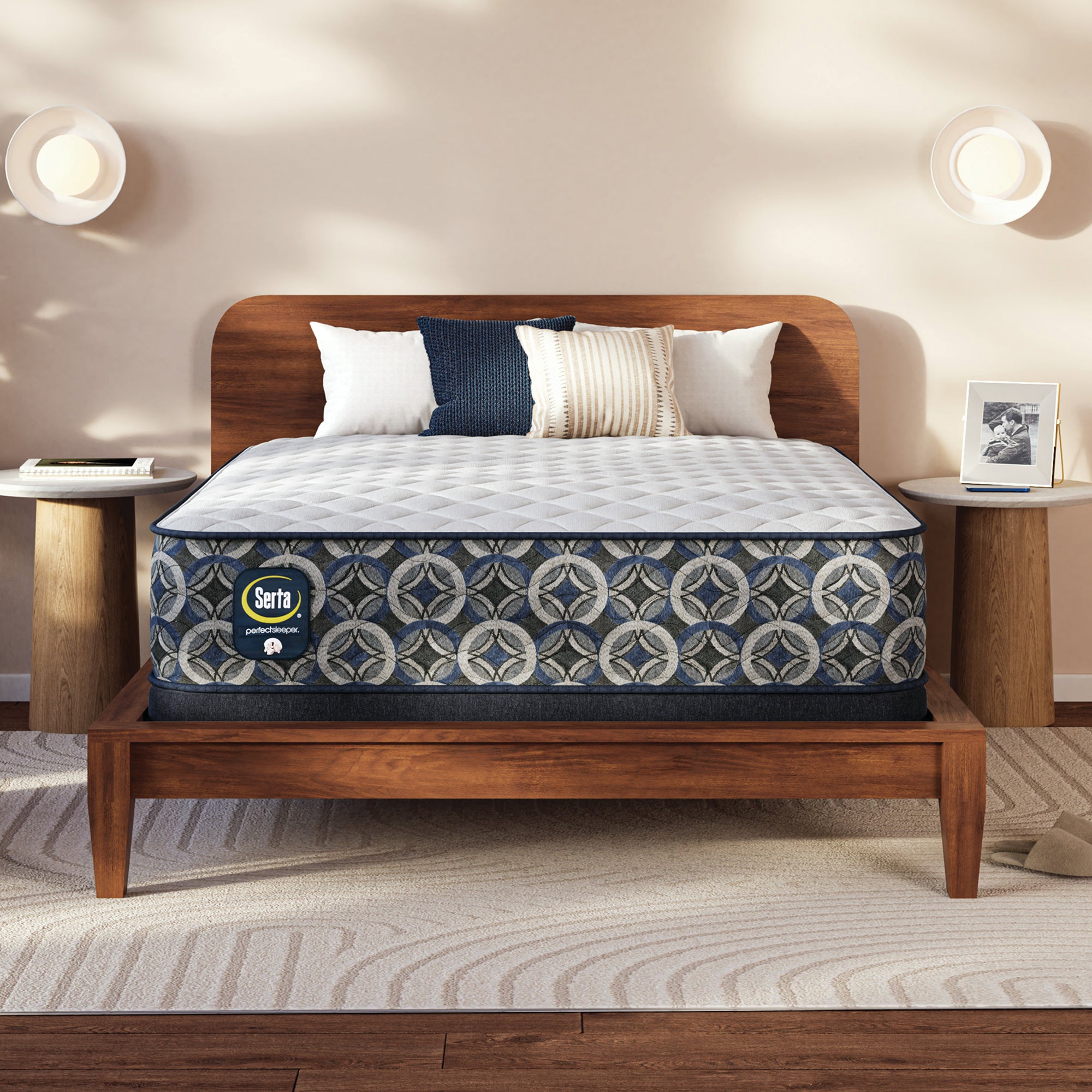 Serta Perfect Sleeper firm mattress on a wooden bed frame in a bedroom setting